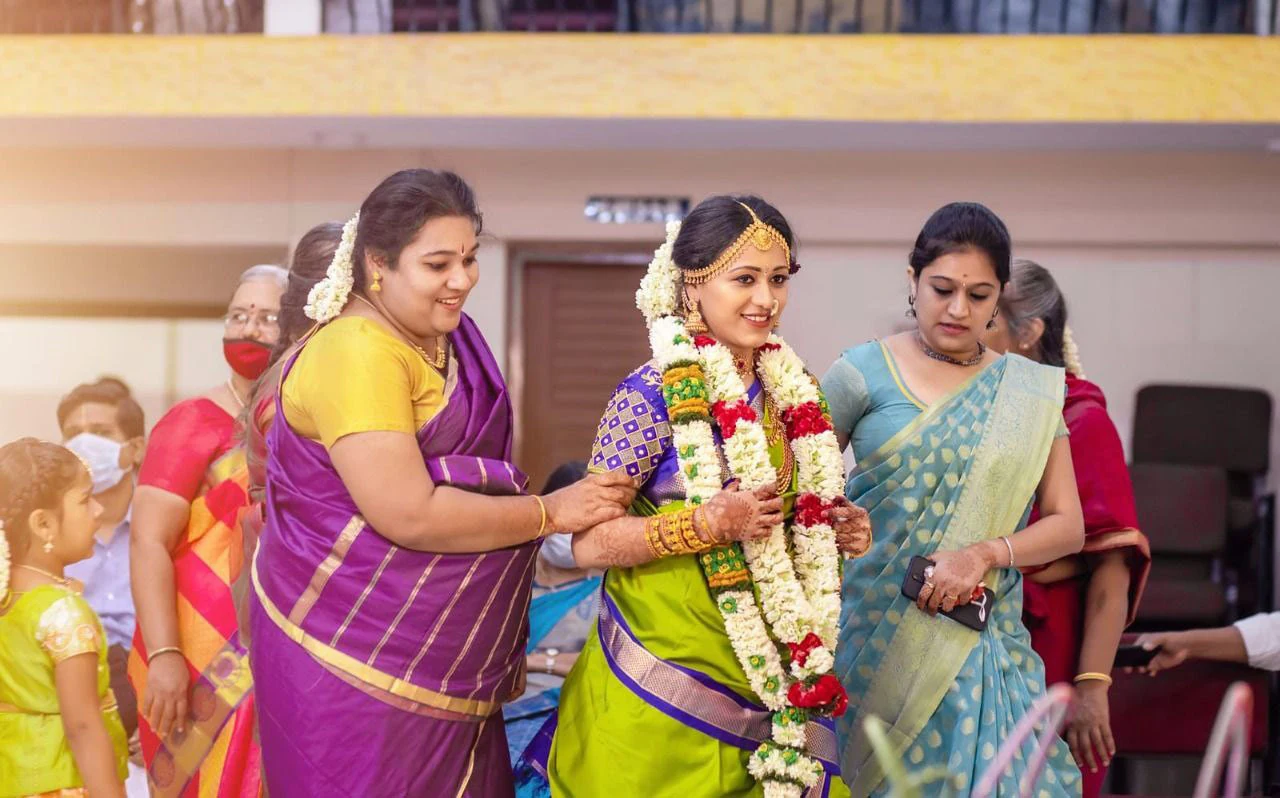 A woman being accompanied by others during a celebration