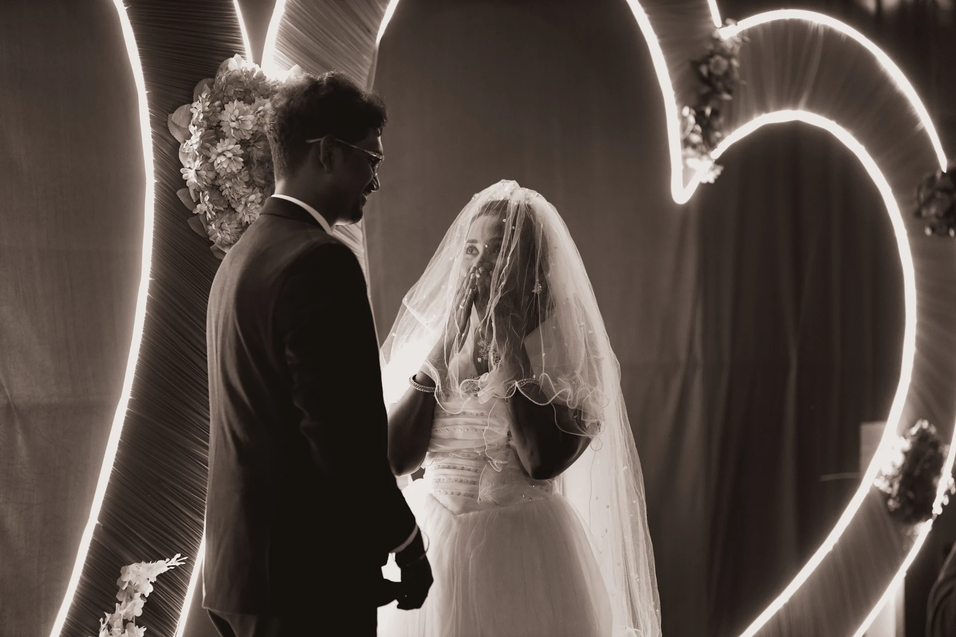Couple facing each other against a circle of light