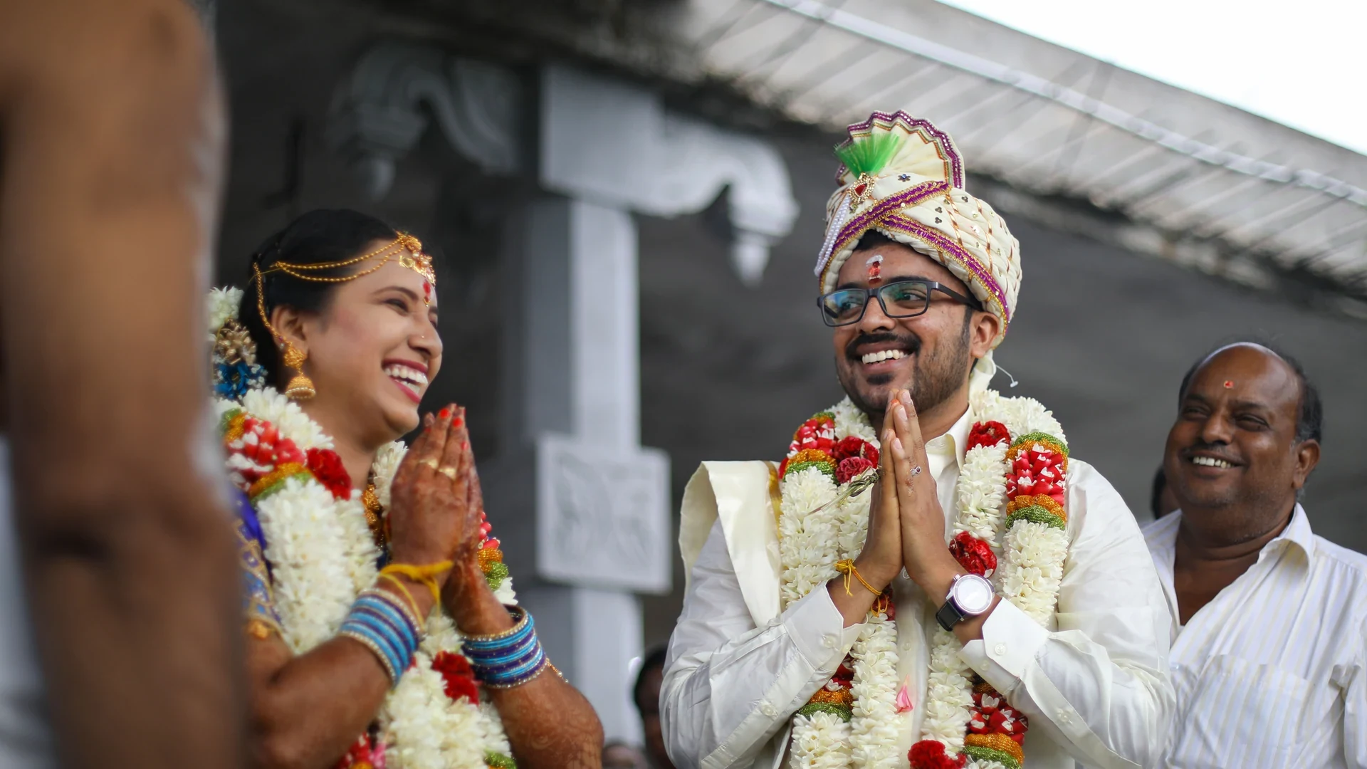 Couple smiling with their hands together during a ceremony