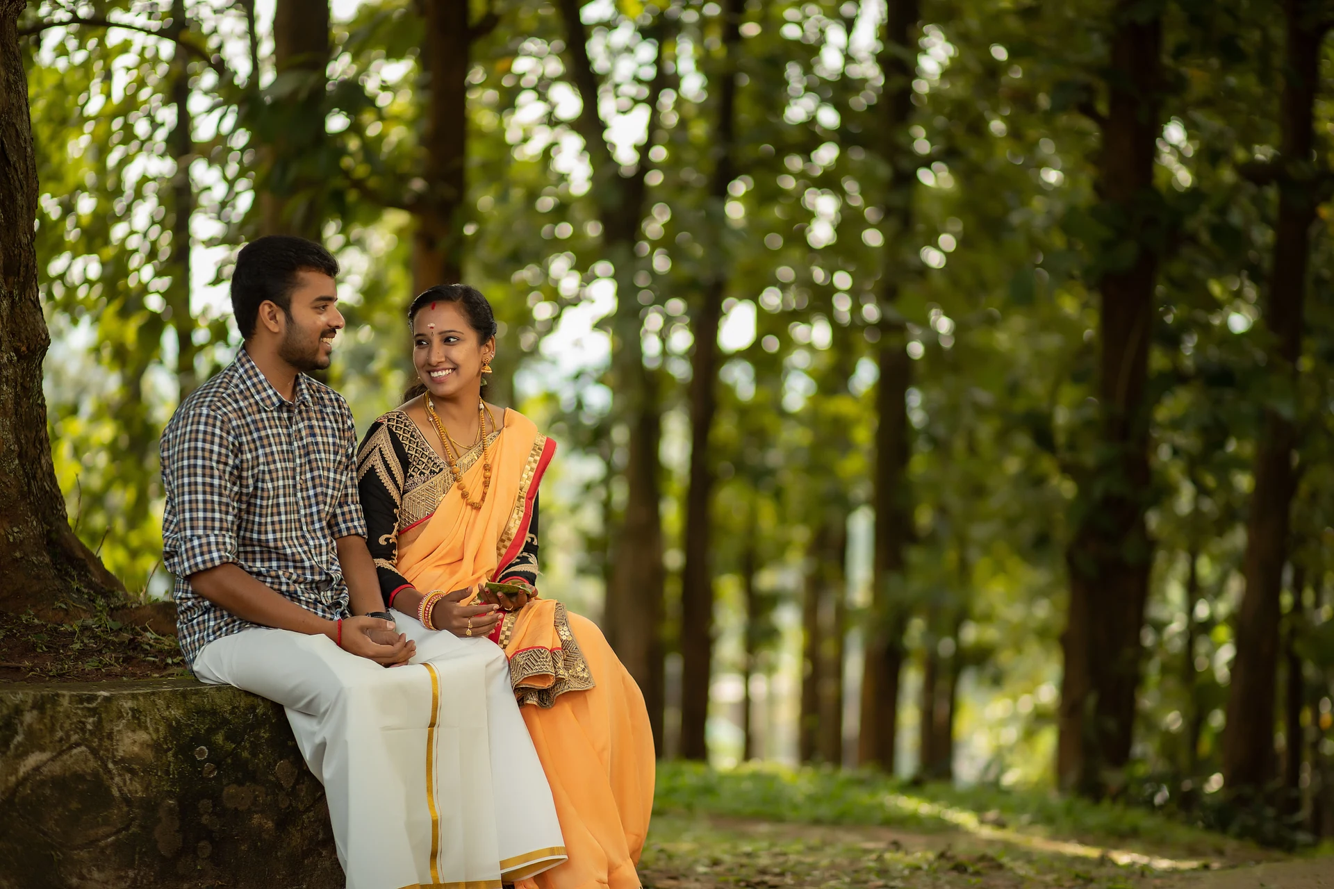 Couple sitting together among trees