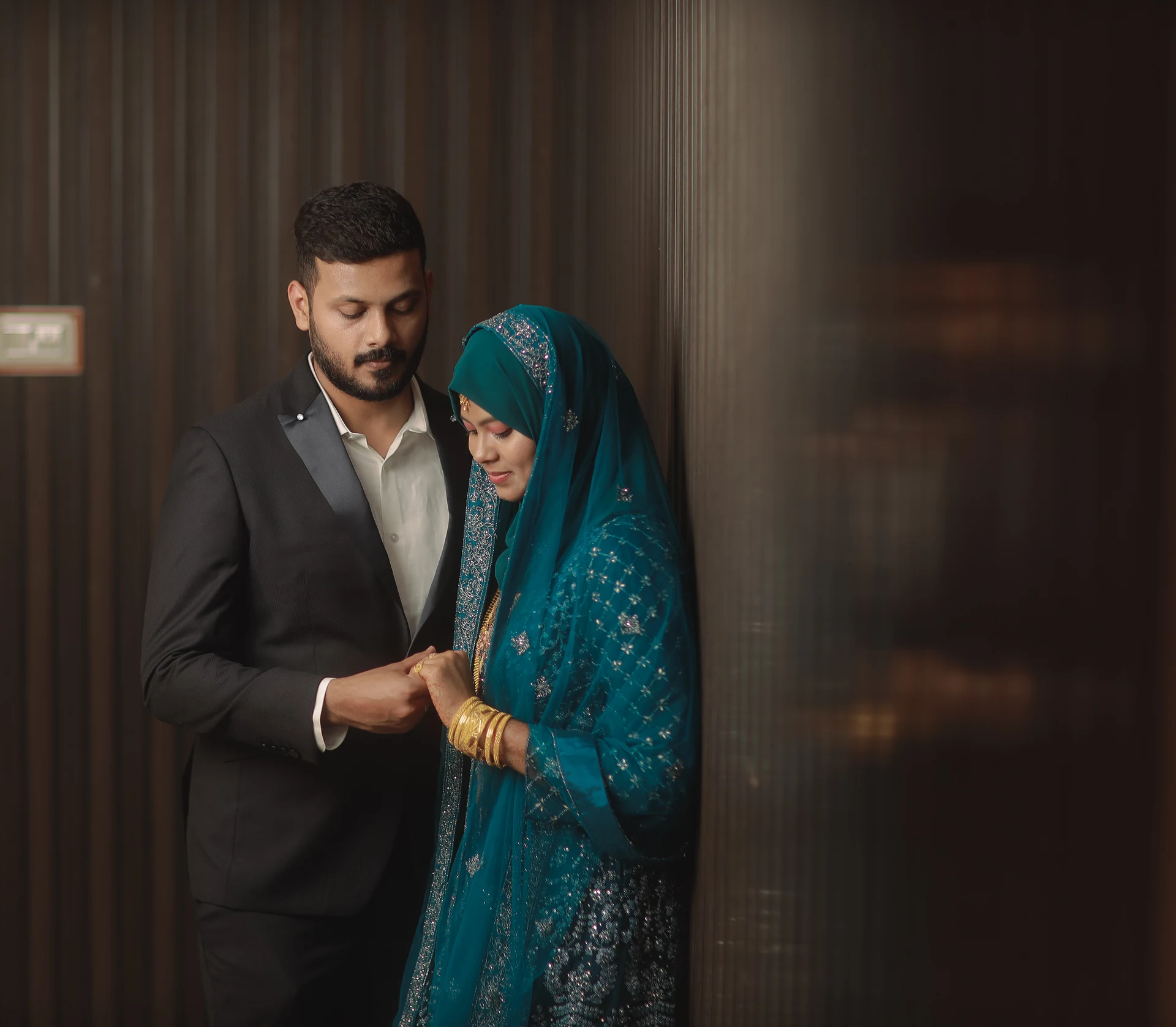 Couple sharing a quiet glance beside a dark doorway