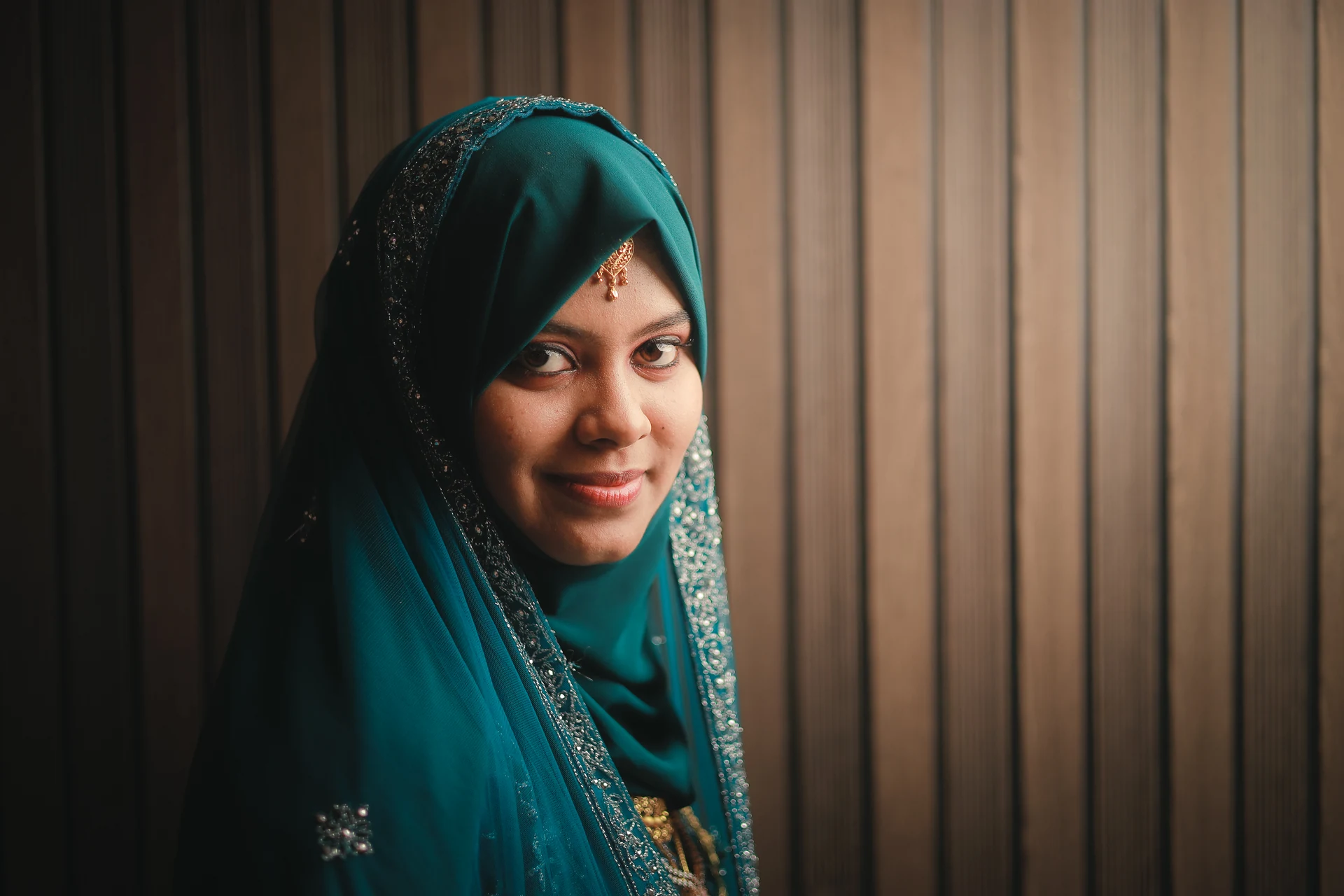 A woman in a blue veil looking towards the camera